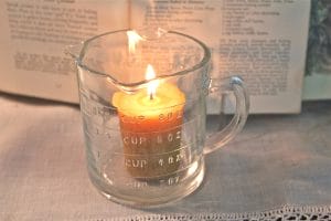 votive candle in a measuring cup